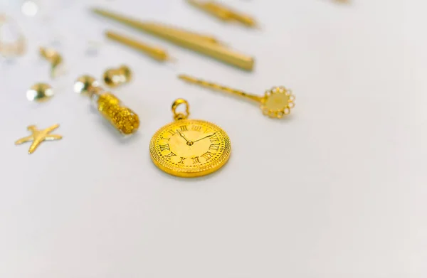 Gold accessories over white background. Pocket gold watch.