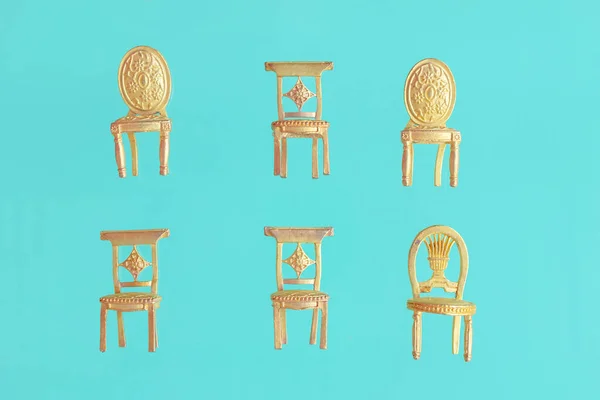 Flying small golden souvenir retro armchairs standing in rows on blue background.Royal chairs, throne.Spring, summer concept for love,romance notes. Creative design for letter, greeting birthday card.