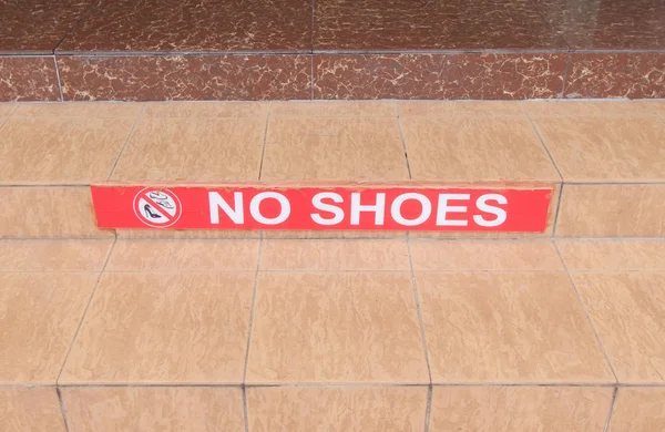 Symbol of no shoes on stair.