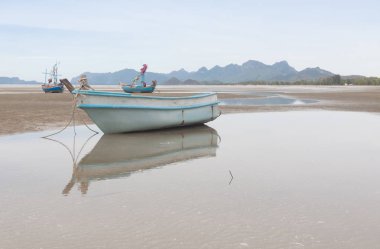 Fiberglas tekne düşük tide plajda yansıması .