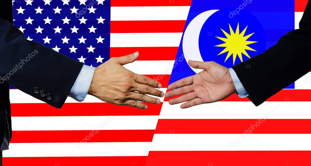 A business man shake each other hand,USA and Malaysia