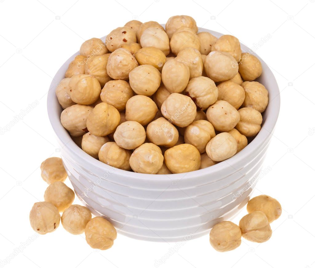 Roasted blanched hazelnuts on white background