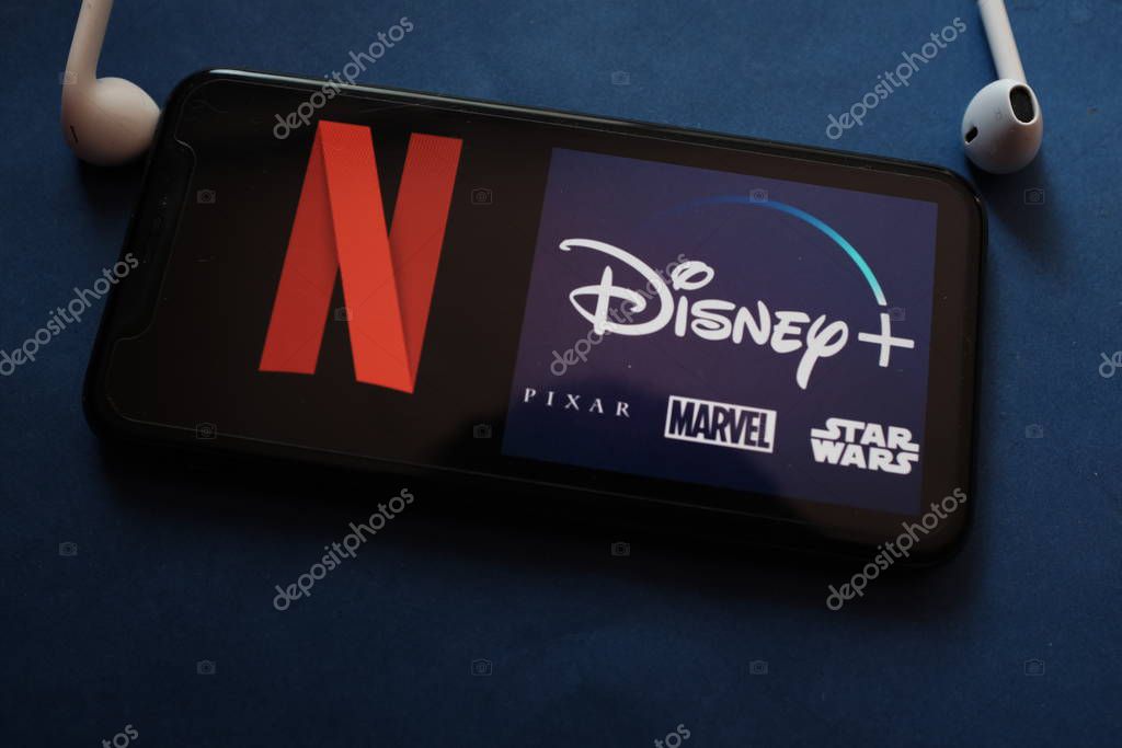 Smart phone with the logo of: DISNEY PLUS and NETFLIX, competing online video services.United States, California, December 10, 2020