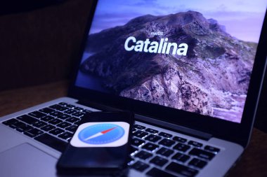 Macbook with the Mac OS Catalina logo which is Apple's desktop operating system for Macintosh computers in the United States, New York. Sunday, October 6, 2019 clipart