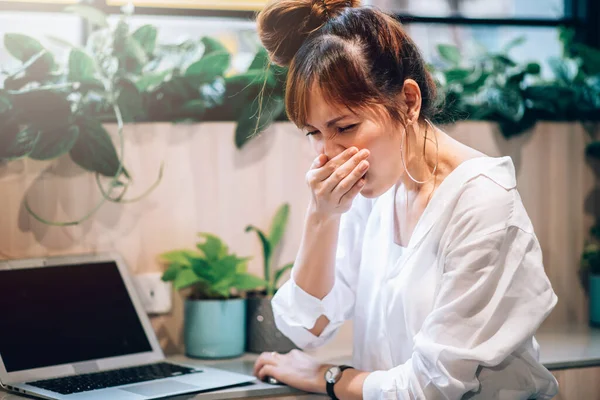 Sick Asian Woman has Fever and Flu Symptoms , Feeling Cold and Sneeze in Office - Healthcare concept