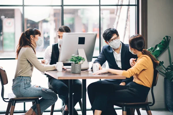 Group of Asian Business People Successful Teamwork in Casual Suit Working Together with Laptop Computer at Co-Working Space