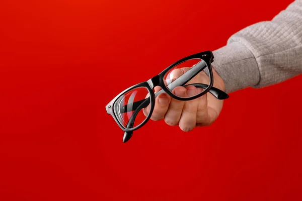 Óculos Mão Sobre Fundo Laranja Simples Imagens De Bancos De Imagens