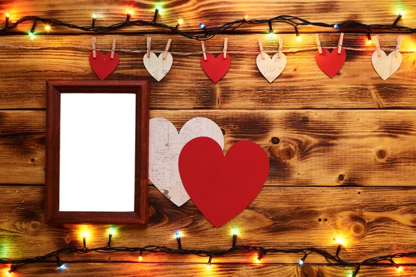 Valentines Day poster with hanging hearts and garlands on wooden background