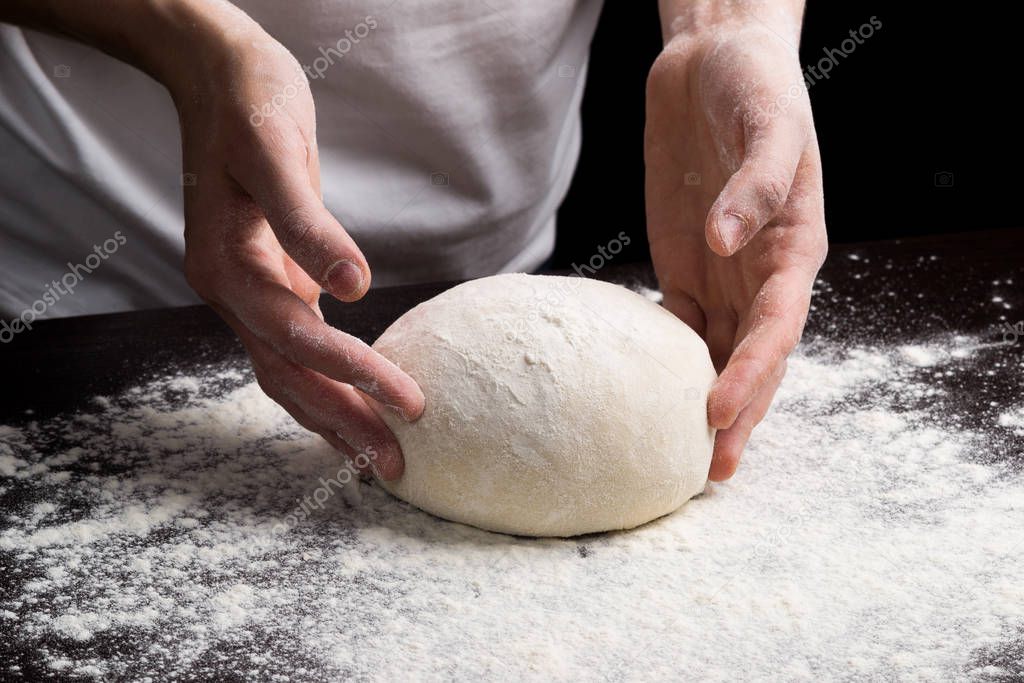 Person cooking dough on table