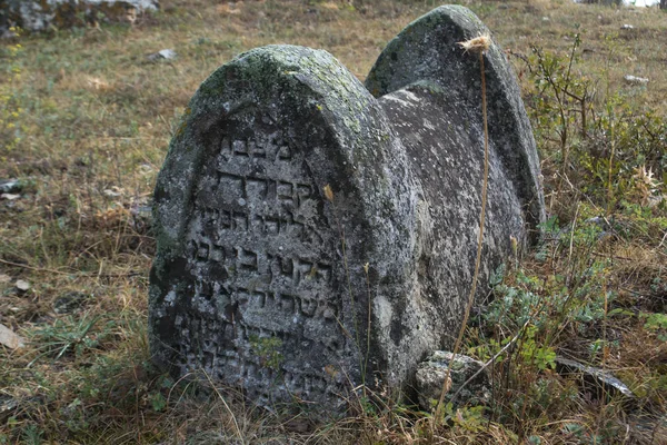 Ancient stone tombstone at Karim cemetery.