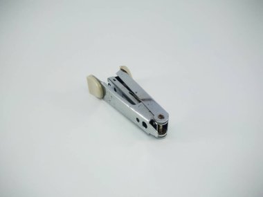 Stapler on white surface table. a device for fastening together sheets of paper with a staple or staples. A stapler is a mechanical device that joins pages of paper or similar material.