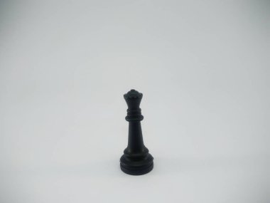 Black plastic queen chess piece isolated on a white background