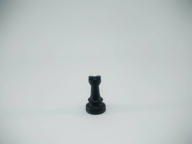 Black plastic rook chess piece isolated on a white background