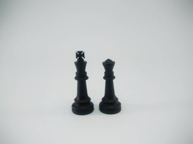 Black plastic couple of king and queen chess piece isolated on a white background