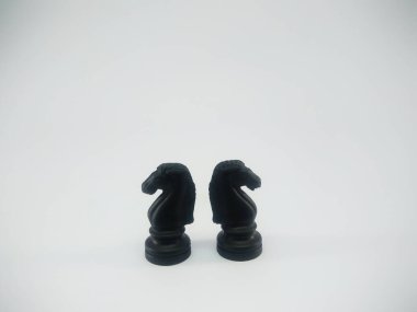 Black plastic pair of knight chess piece isolated on a white background