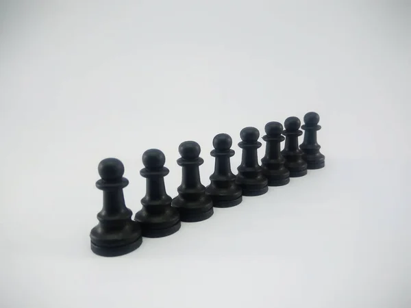 Black plastic line of pawn chess piece isolated on a white background — ストック写真