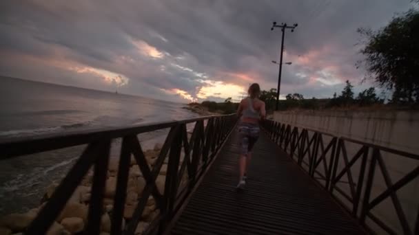 Fitness model running by sea — Stock Video