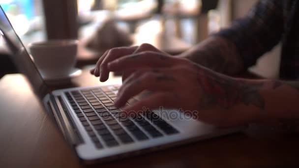 Cool guy writing on portable pc — Stock Video