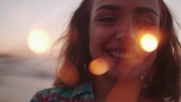 Женщина держит фейерверк и улыбается — стоковое видео