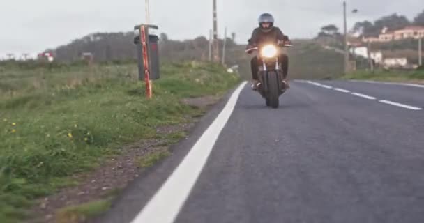 Hombre motociclista montando en motocicleta clásica en carretera de campo — Vídeos de Stock