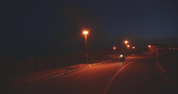 Man riding fast on classic motorcycle at night — Stock Video