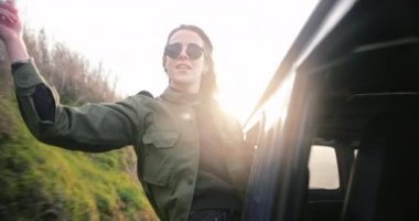 Minibüsün camından sarkan genç ve çekici kadın.