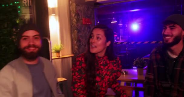 Multi-ethnic group of friends laughing together inside trendy cocktail bar — Stock Video