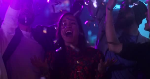 Multietnisk grupp vänner dansar tillsammans, kastar konfetti inne bar — Stockvideo