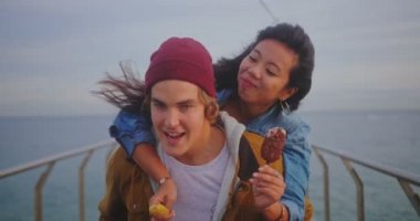 Çiftler rıhtımda gezip dondurma yerken eğleniyorlar.