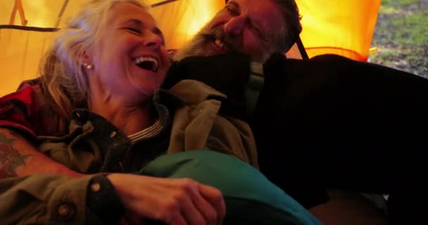 Close-up senior couple lying down together with dog inside tent — Stock Video