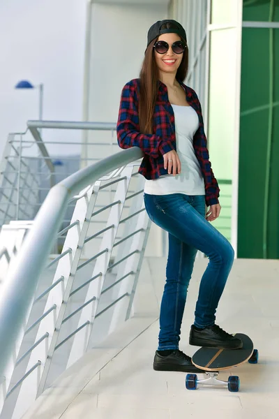 Trendy perempuan dalam kacamata hitam dengan skate — Stok Foto