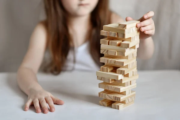 Little Girl Plays Jenga White Clothes Light Background — 스톡 사진