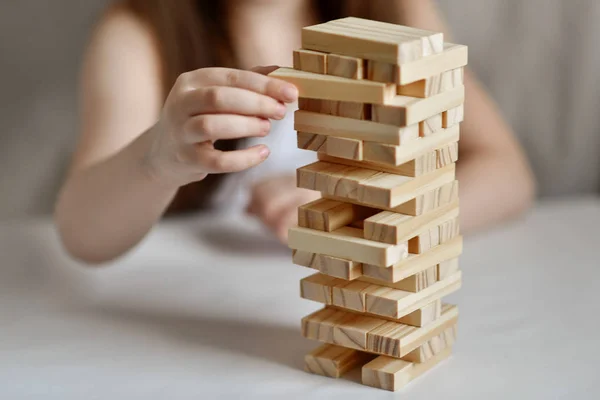 Little Girl Plays Jenga White Clothes Light Background — 스톡 사진