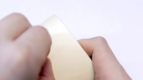 As mãos do homem não conseguem encontrar a borda de uma fita adesiva — Vídeo de Stock