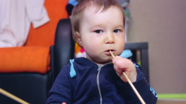 Child boy eating chinese chopsticks at home — Stock Video