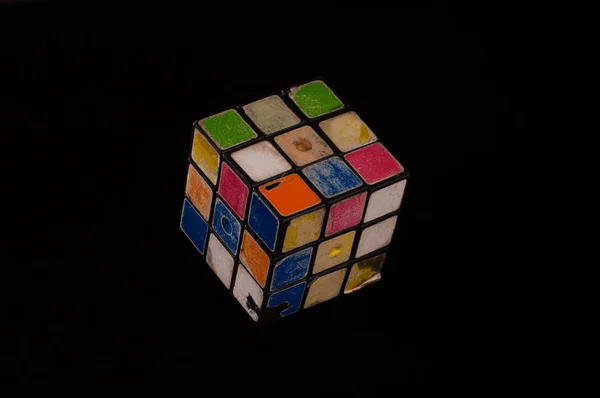 Rubik cube worn by continuous play with all its colors — Stok fotoğraf