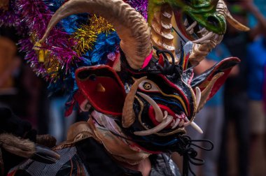 PILLARO, ECUADOR - JANUARY 3, 2020: Person in a red devil mask at the Diablada or Devil Festival
