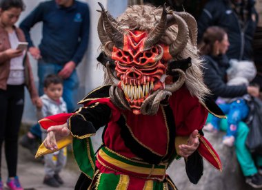 PILLARO, ECUADOR - JANUARY 3, 2020: Person in a red devil mask at the Diablada or Devil Festival