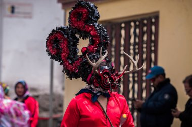 PILLARO, ECUADOR - JANUARY 3, 2020: Person in a red devil mask at the Diablada or Devil Festival