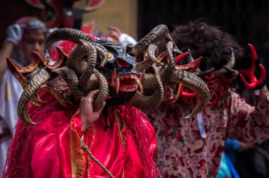 PILLARO, ECUADOR - JANUARY 3, 2020: Person in a red devil mask at the Diablada or Devil Festival