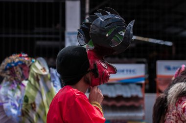 PILLARO, ECUADOR - JANUARY 3, 2020: Person in a red devil mask at the Diablada or Devil Festival
