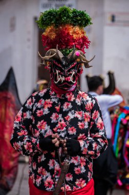 PILLARO, ECUADOR - JANUARY 3, 2020: Person in a red devil mask at the Diablada or Devil Festival