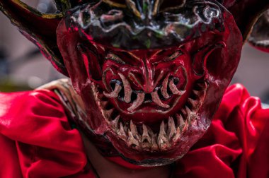 PILLARO, ECUADOR - JANUARY 3, 2020: Person in a red devil mask at the Diablada or Devil Festival