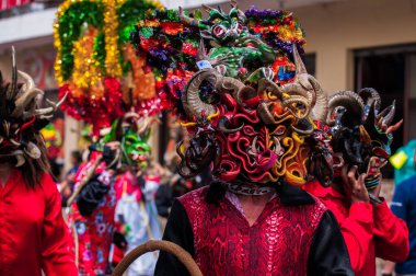 PILLARO, ECUADOR - JANUARY 3, 2020: Person in a red devil mask at the Diablada or Devil Festival