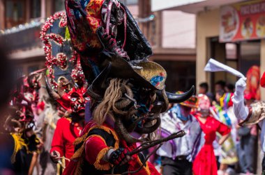 PILLARO, ECUADOR - JANUARY 3, 2020: Person in a red devil mask at the Diablada or Devil Festival