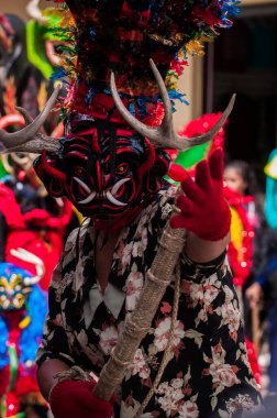 PILLARO, ECUADOR - JANUARY 3, 2020: Person in a red devil mask at the Diablada or Devil Festival