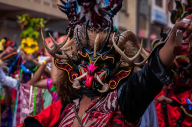 PILLARO, ECUADOR - JANUARY 3, 2020: Person in a red devil mask at the Diablada or Devil Festival
