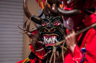 PILLARO, ECUADOR - JANUARY 3, 2020: Person in a red devil mask at the Diablada or Devil Festival