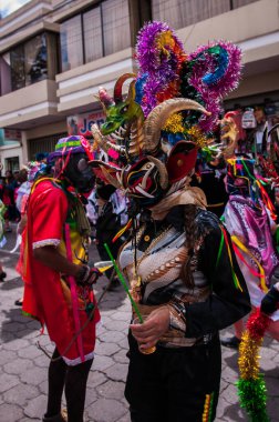 PILLARO, ECUADOR - JANUARY 3, 2020: Person in a red devil mask at the Diablada or Devil Festival
