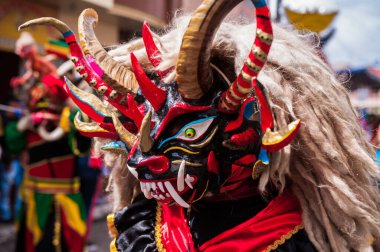 PILLARO, ECUADOR - JANUARY 3, 2020: Person in a red devil mask at the Diablada or Devil Festival